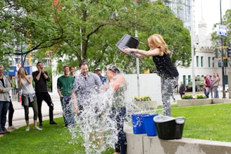 woman pouring water on another person