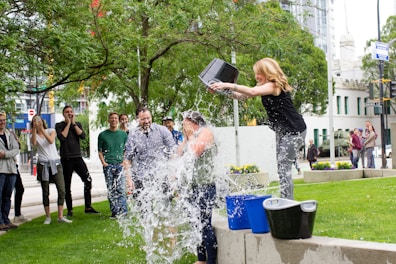 woman pouring water on another person