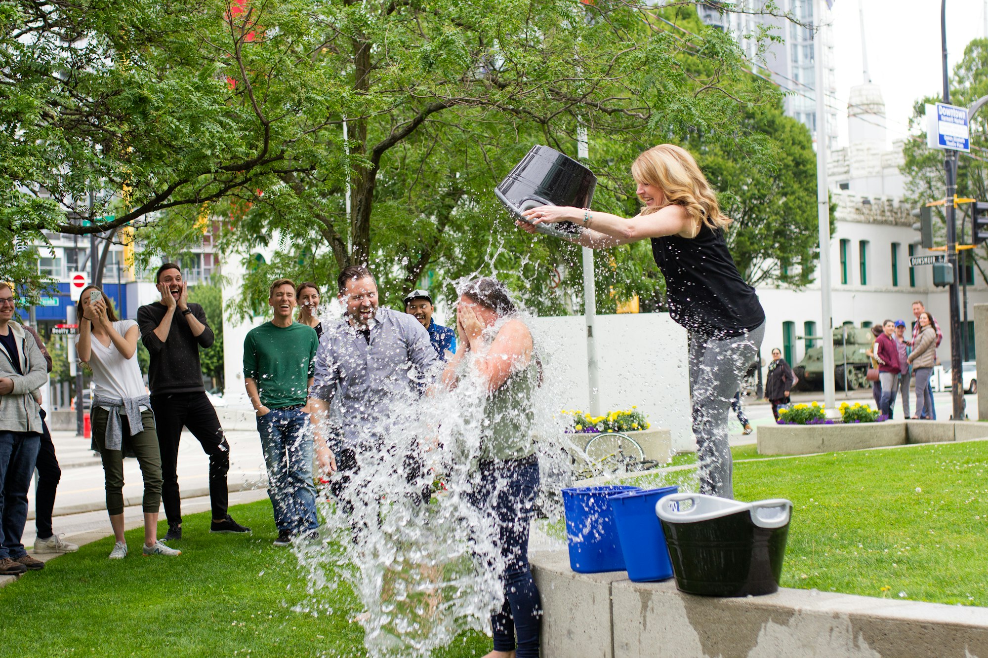 woman pouring water on another person for ice bucket challenge 