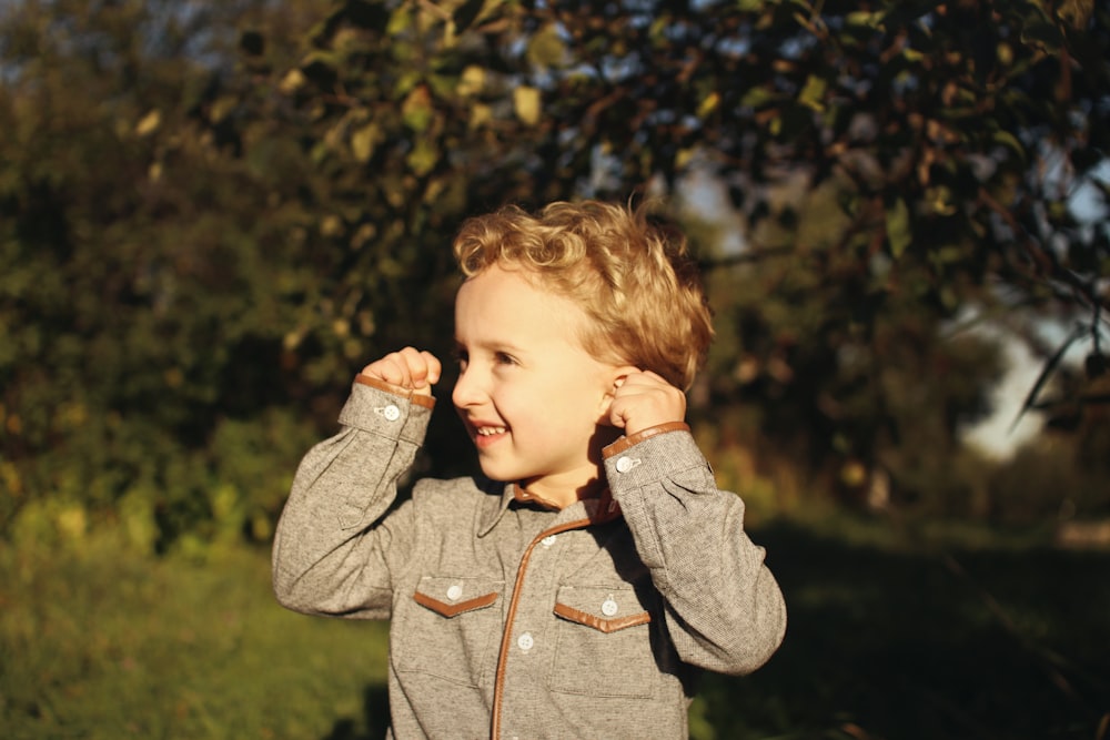 boy raising both hands