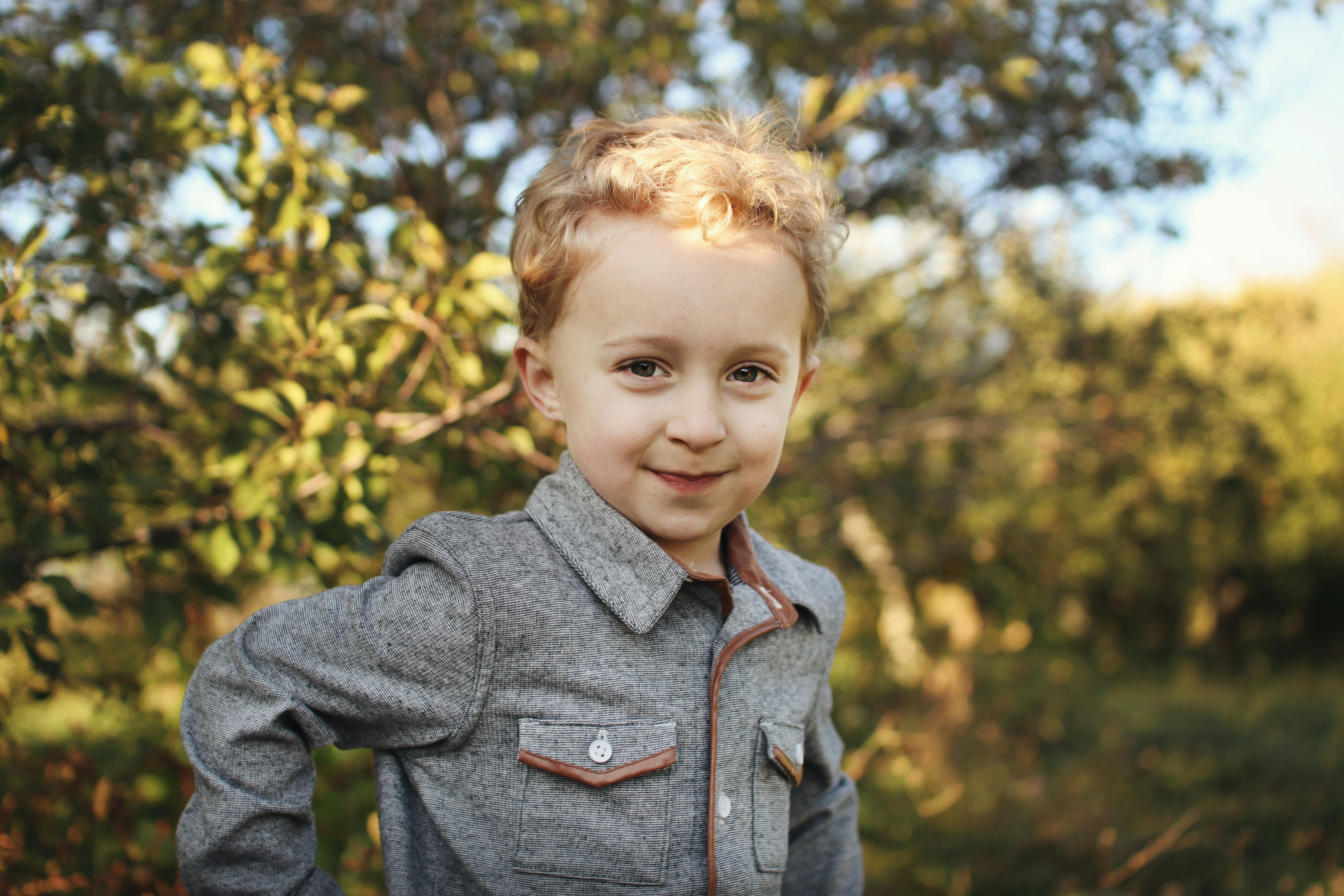 Boy standing near tree at daytime
