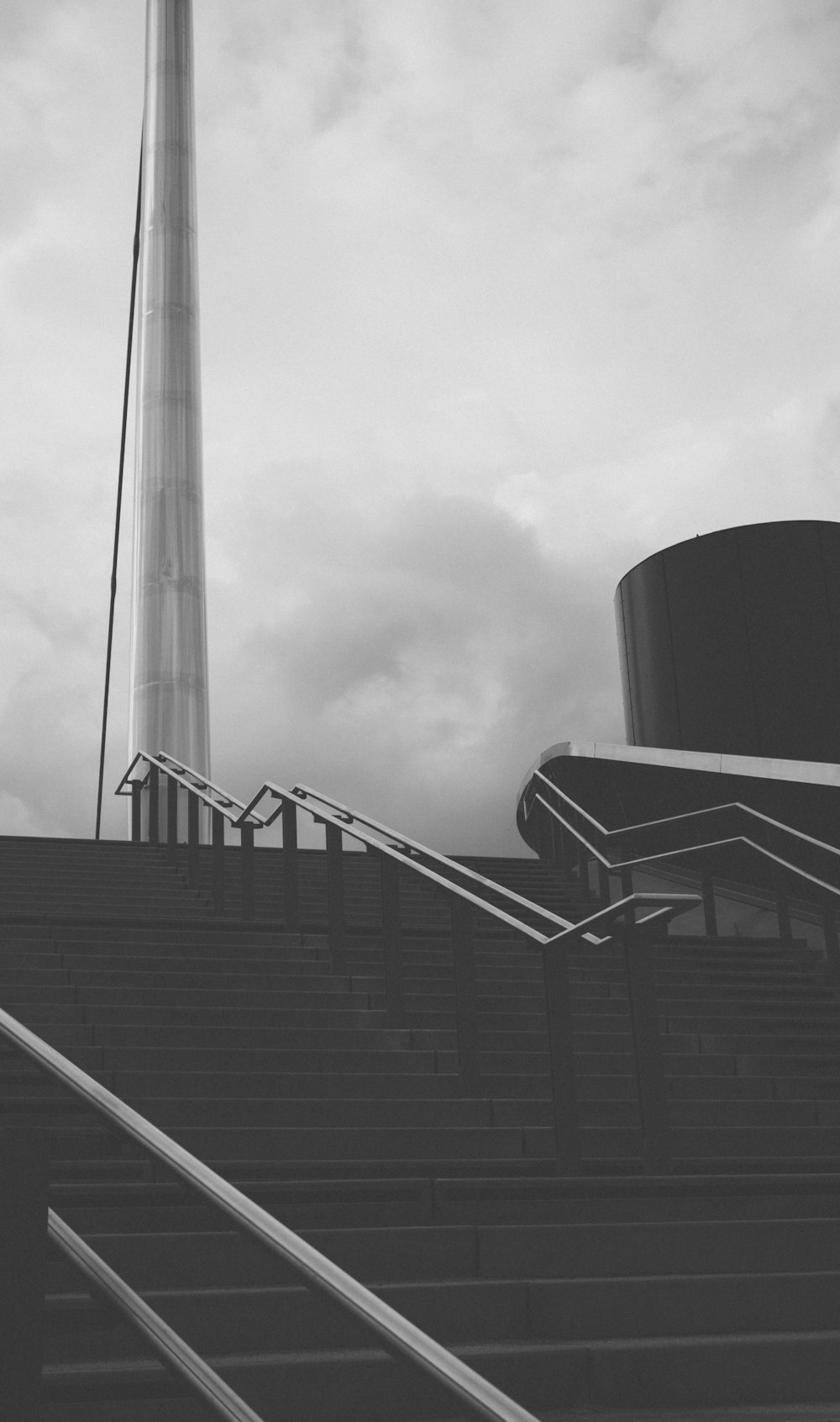 a black and white photo of stairs leading up to a tower