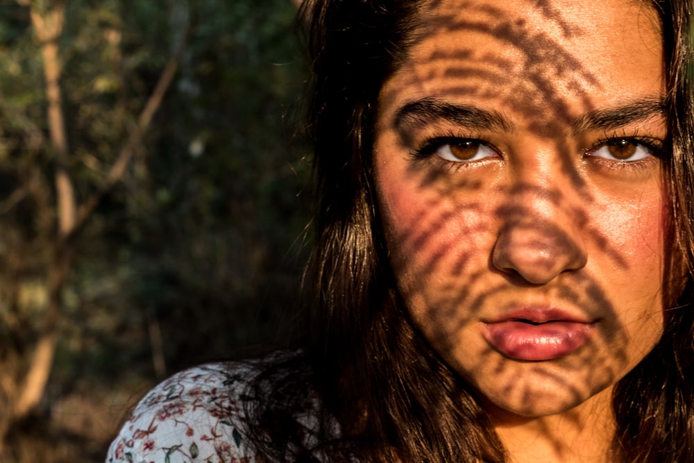 a woman's face with a shadow on her face