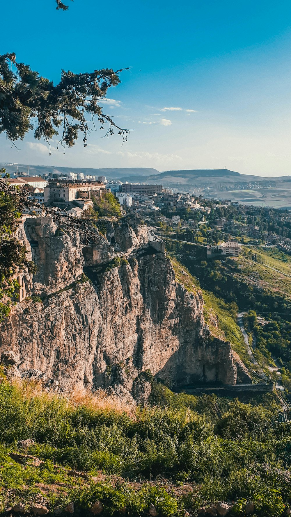 a scenic view of a city on a cliff