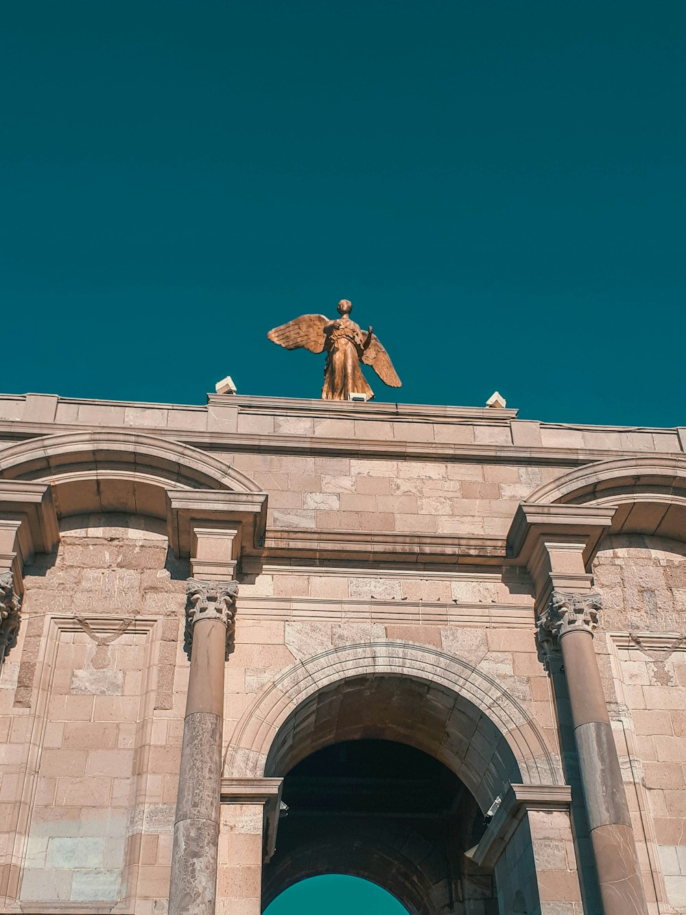 a statue of an angel on top of a building