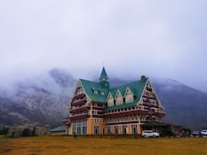 brown and yellow concrete cathedral near mountain at daytime