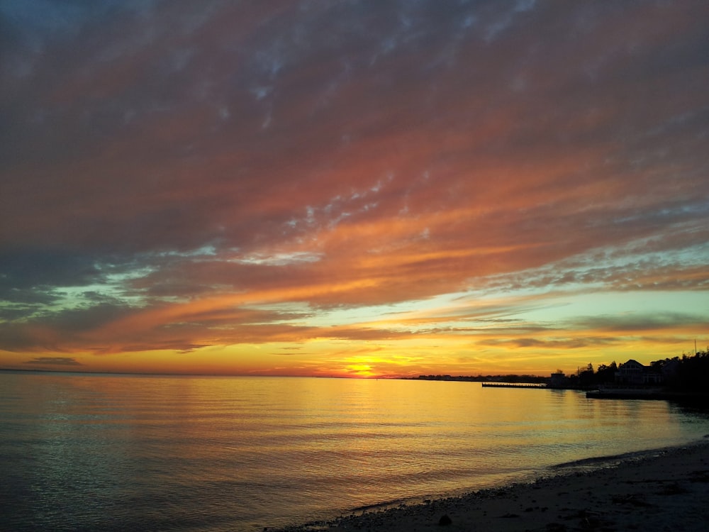 calm body of water during golden hour