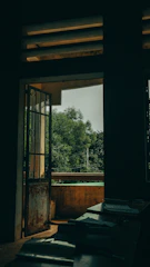 View of the room’s balcony overlooking a quiet courtyard with greenery.