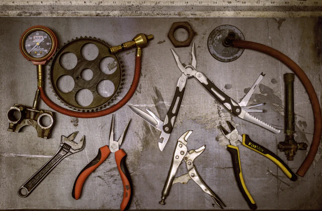 Assorted hand tools arranged on a bench
