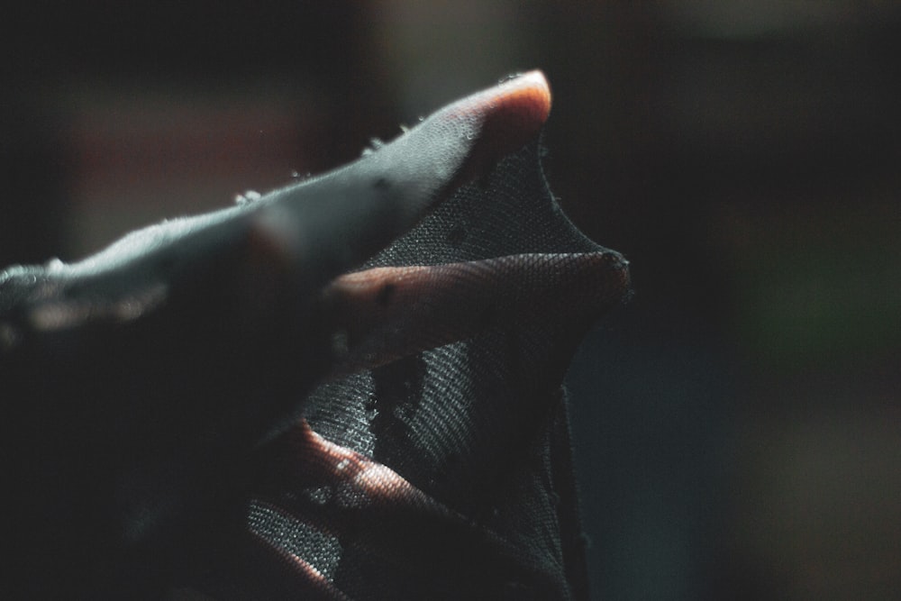 a close up of a person's hand holding a pair of scissors