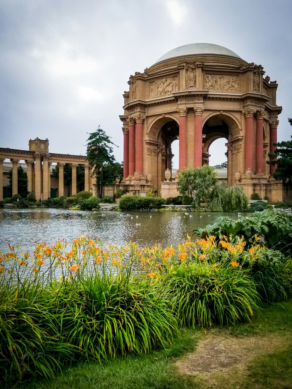 a large building with a pond in front of it