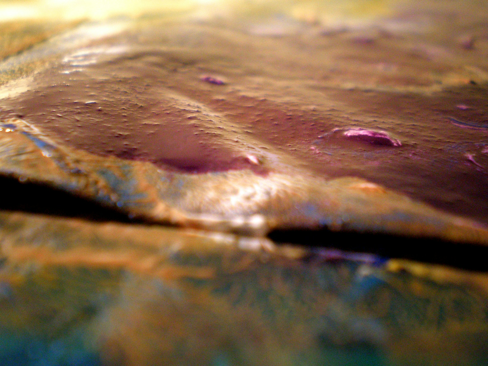 A close-up of a textured Ruibal artwork with shimmering layers revealing subtle, invisible luxury.