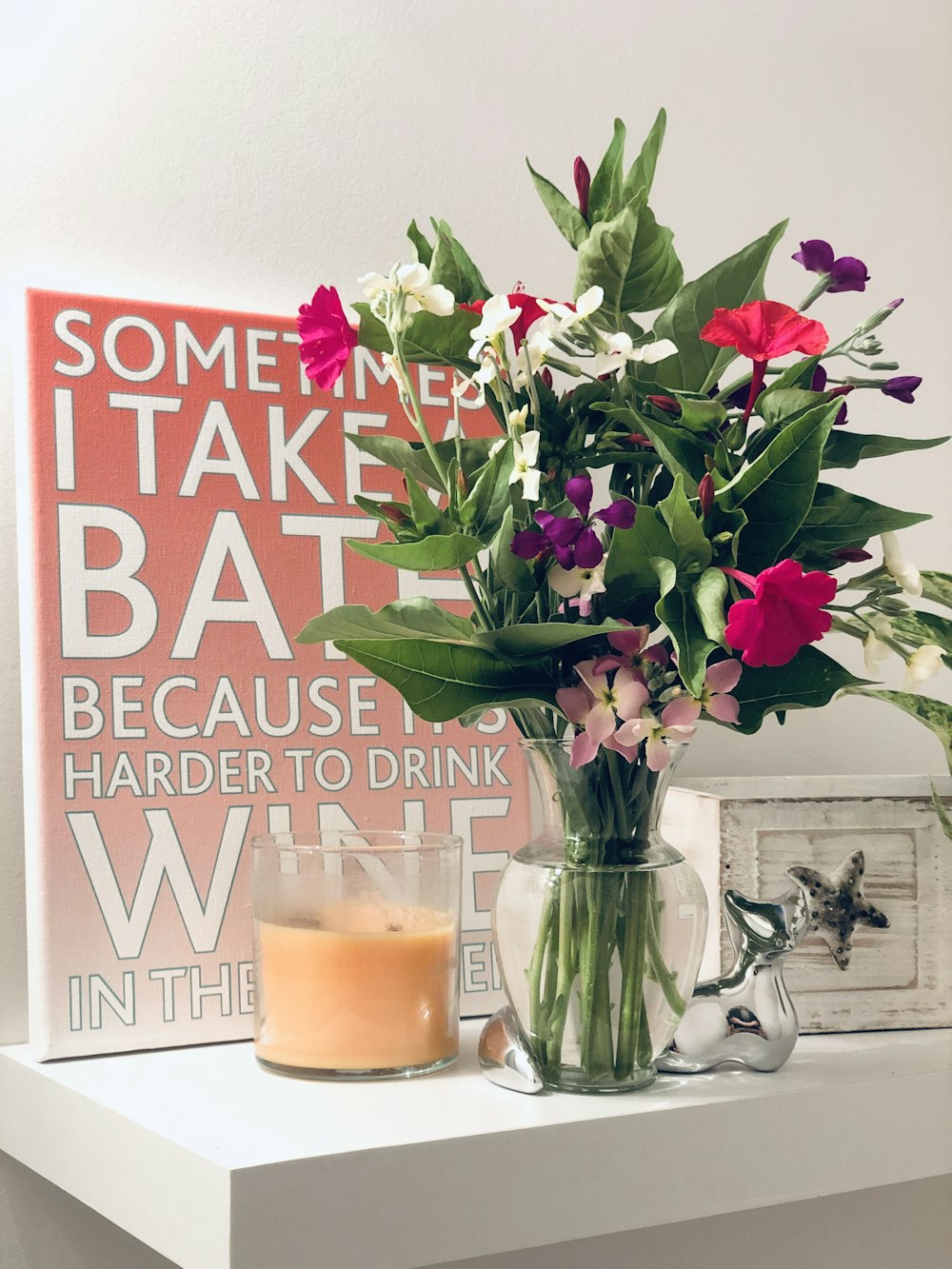 flowers in vase beside sign