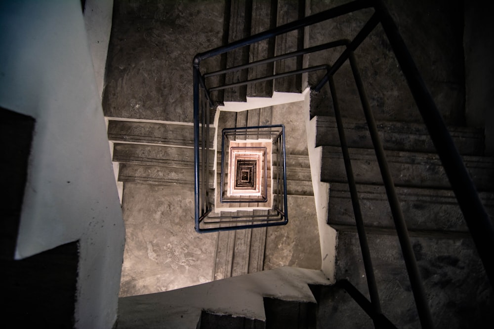 a spiral staircase with a light at the end