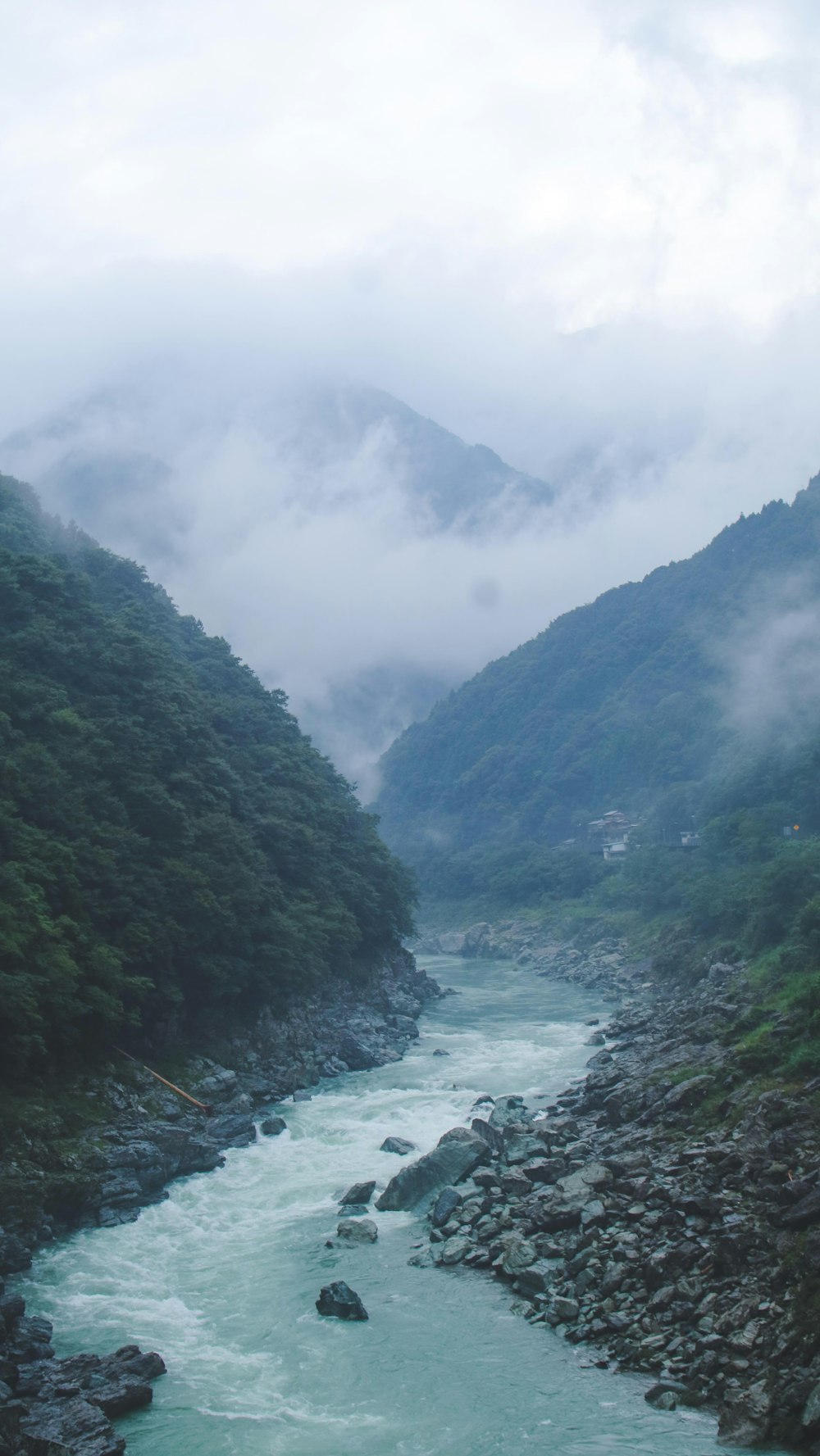 body of water between mountains at daytime