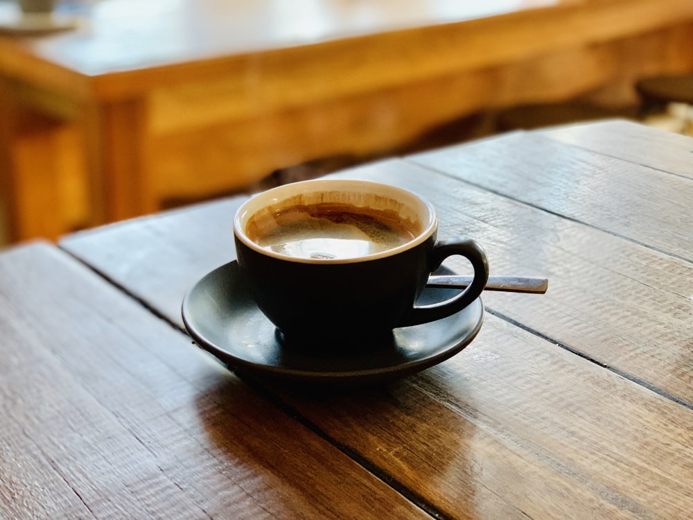 black ceramic mug on saucer