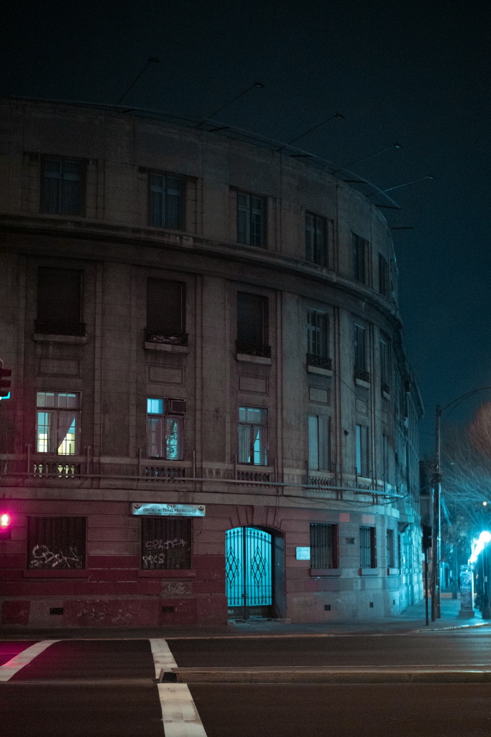 a city street at night with a traffic light