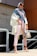 A happy customer wearing a stylish outfit in a bright, outdoor setting.