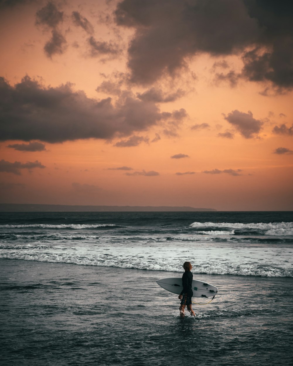 person holding surfboard