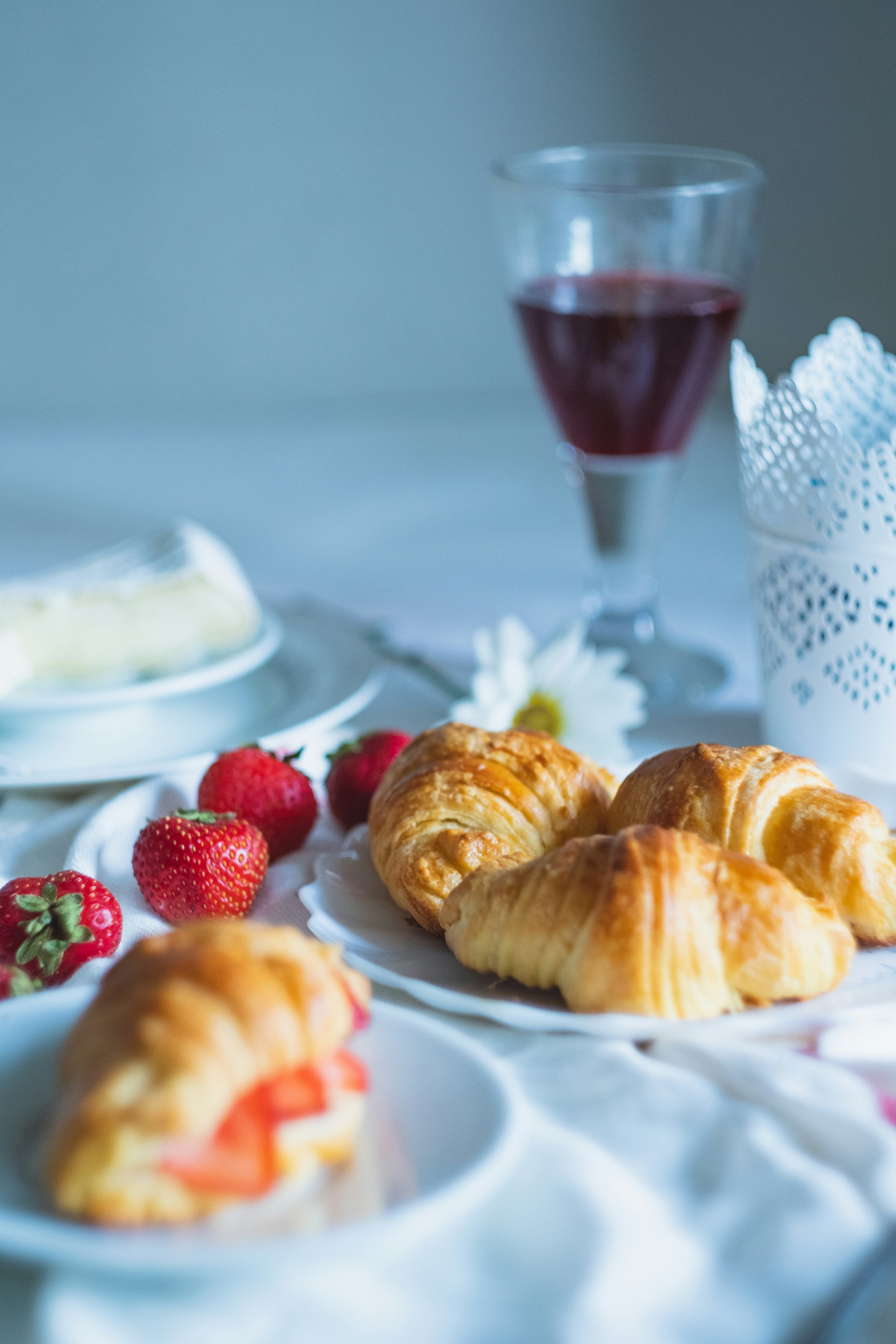 croissant in plate near strawberry fruits