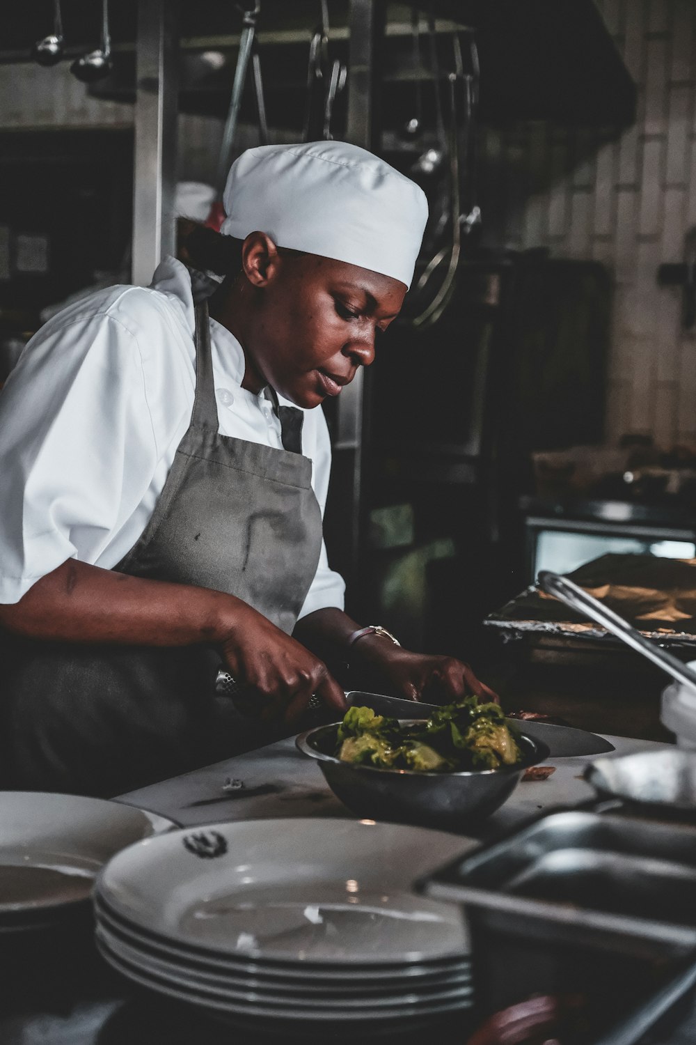 chef using knife front of bowl