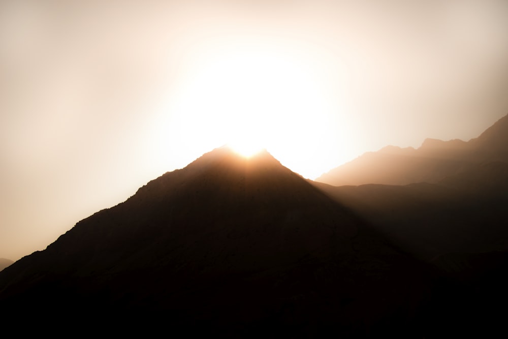 sun rays coming through mountain