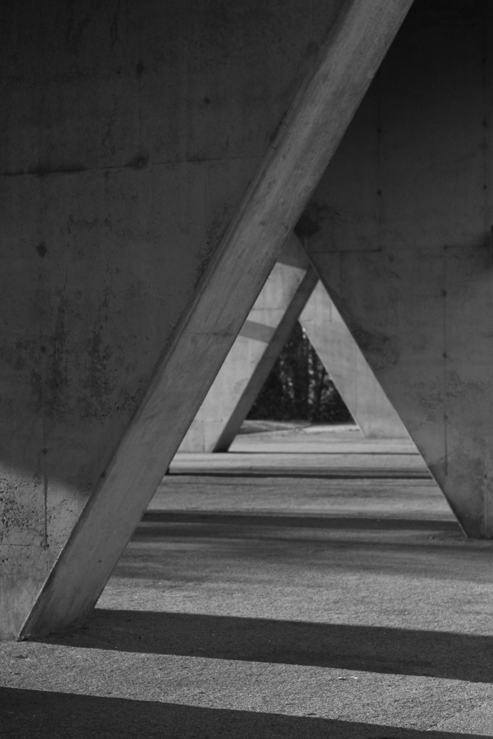 greyscale photo of triangular tunnel