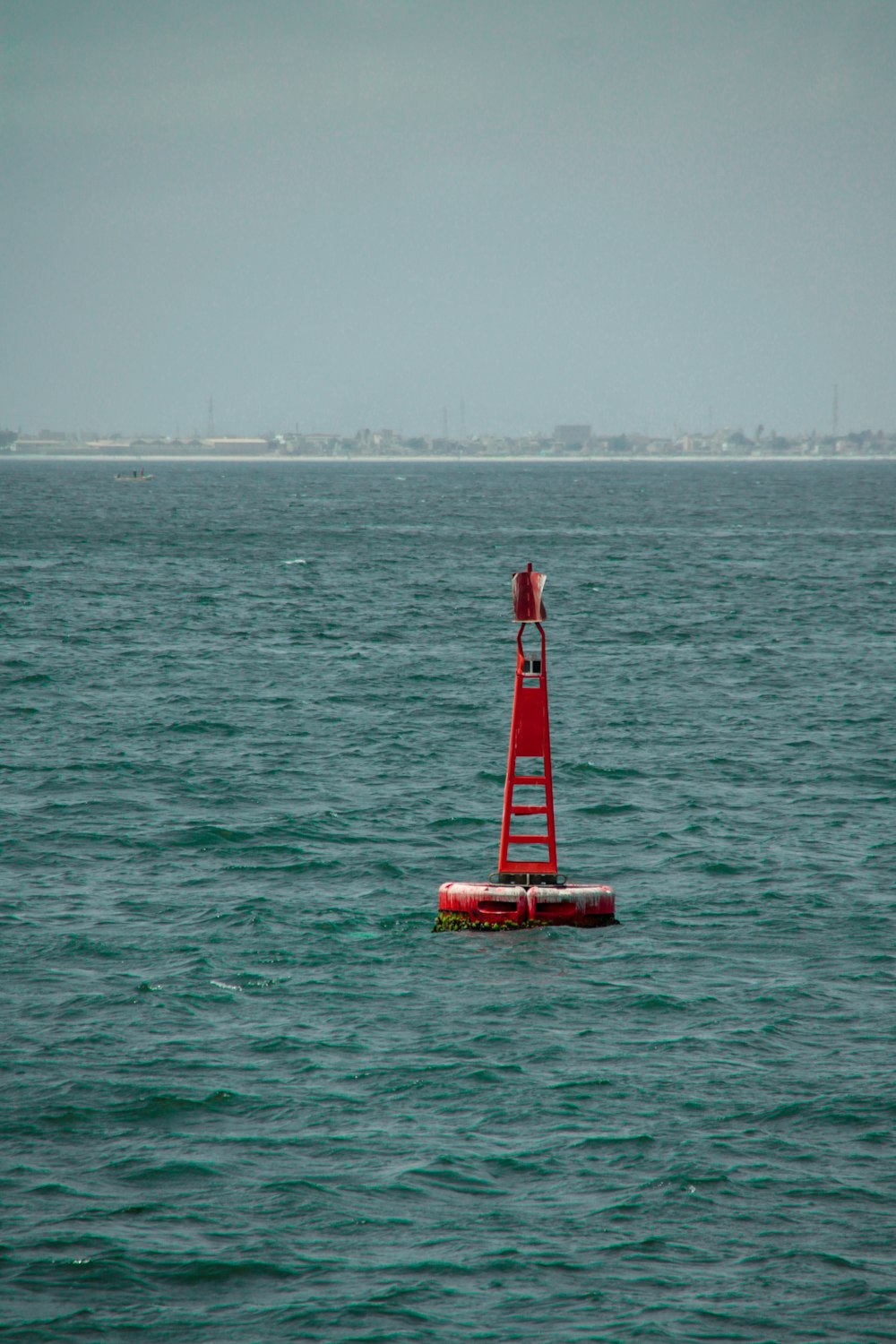 body of water under gray sky at daytime