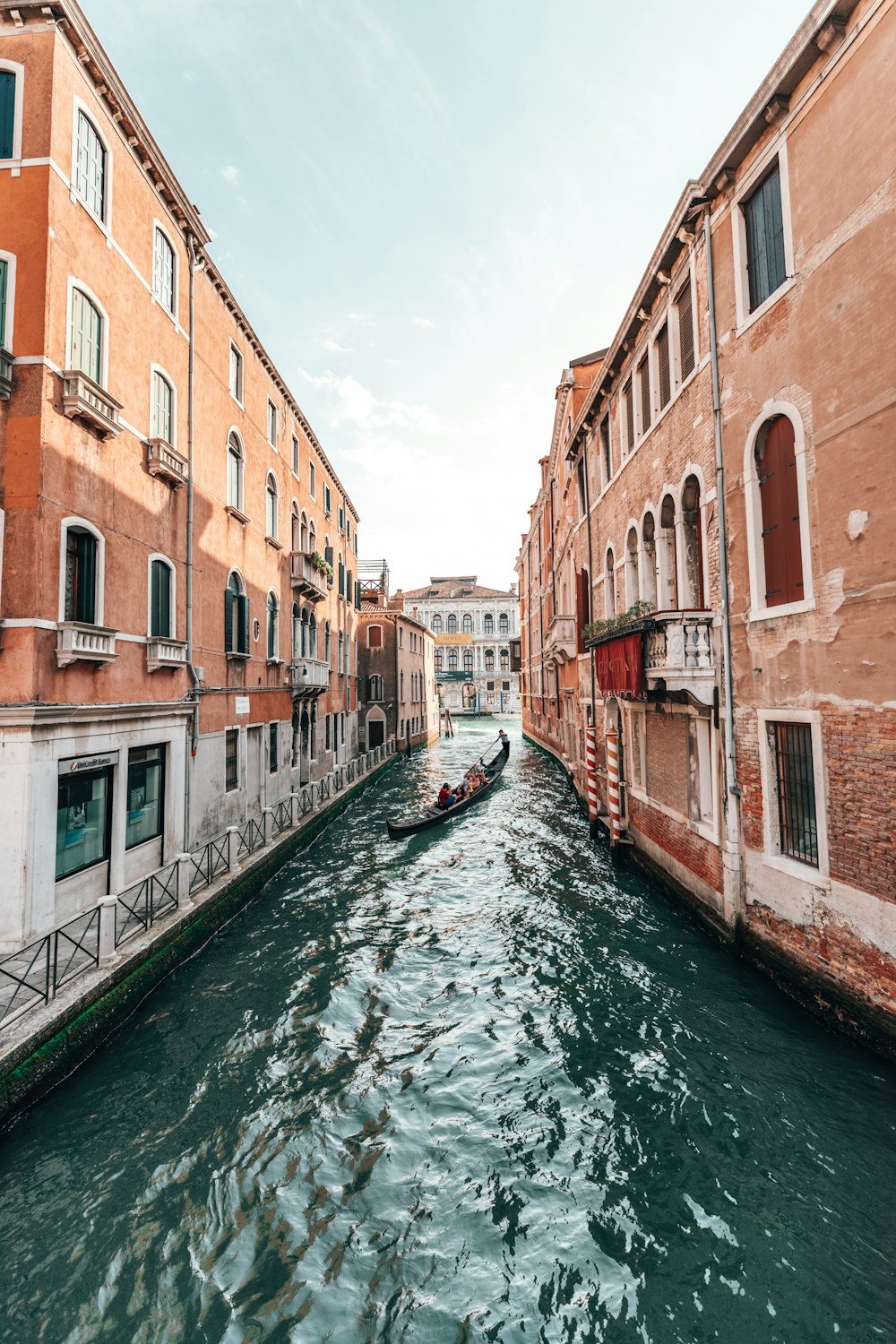 venice river between orange buildings