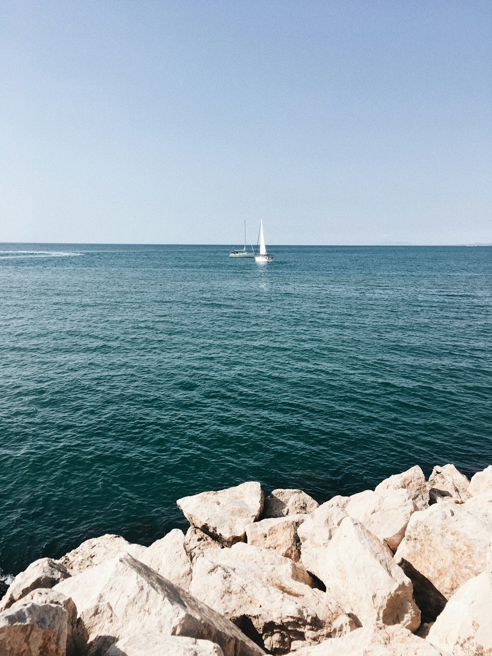 white sailboat on ocean during daytime