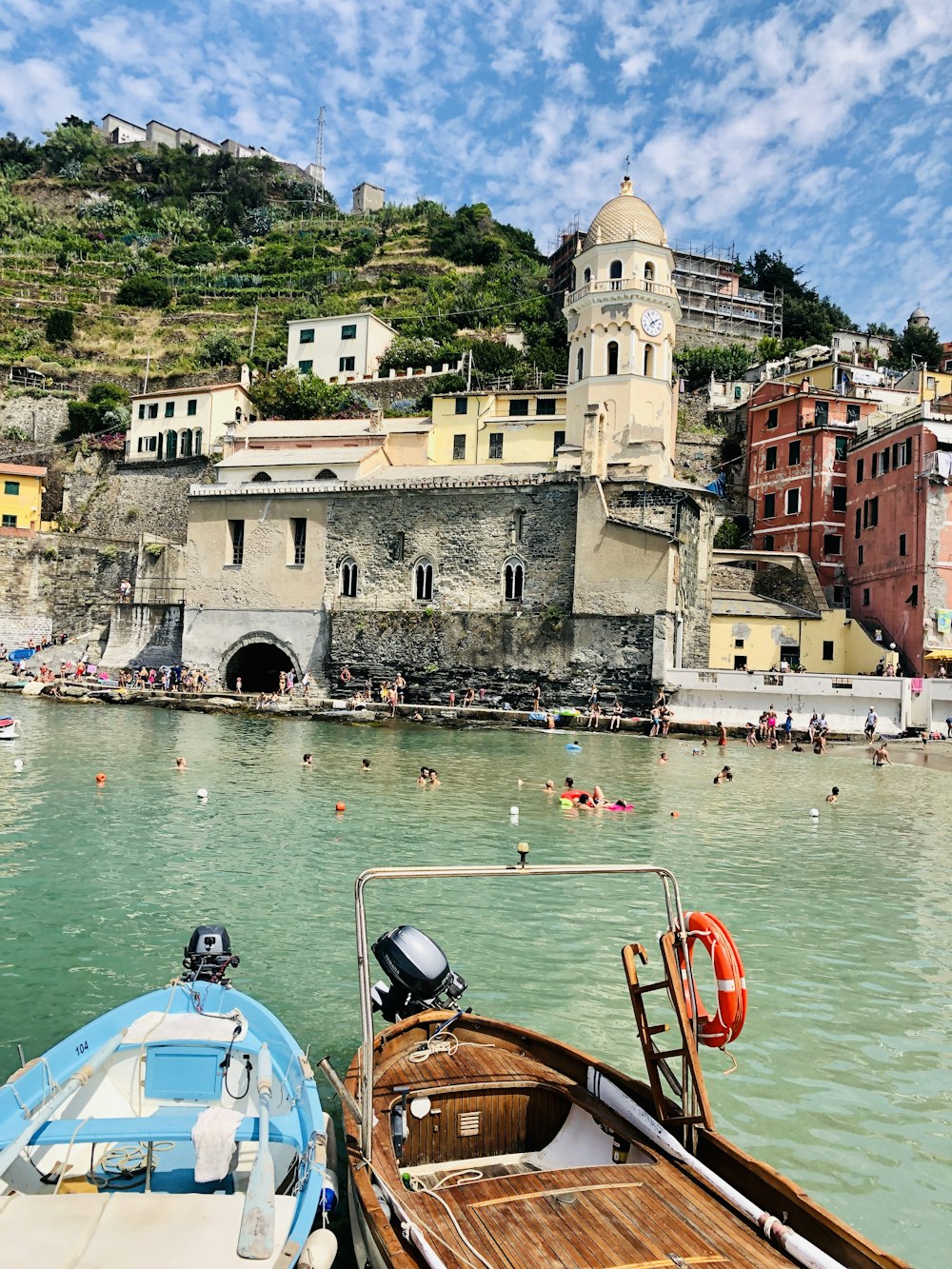 people swimming in sea beside church