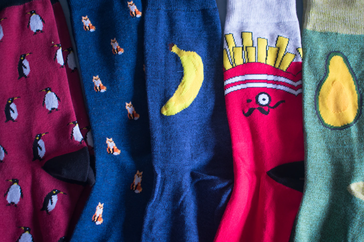 Carrer novelty crew socks printed with foxes, bananas and chips, hanging on a rack, in stock