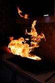 Flames dancing from a sauté pan in the kitchen.