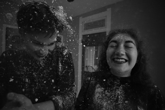 People playfully teasing each other with exaggerated gestures and laughter.