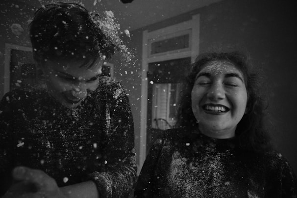 Two actors portraying a comedic double date, laughter lighting up the scene.