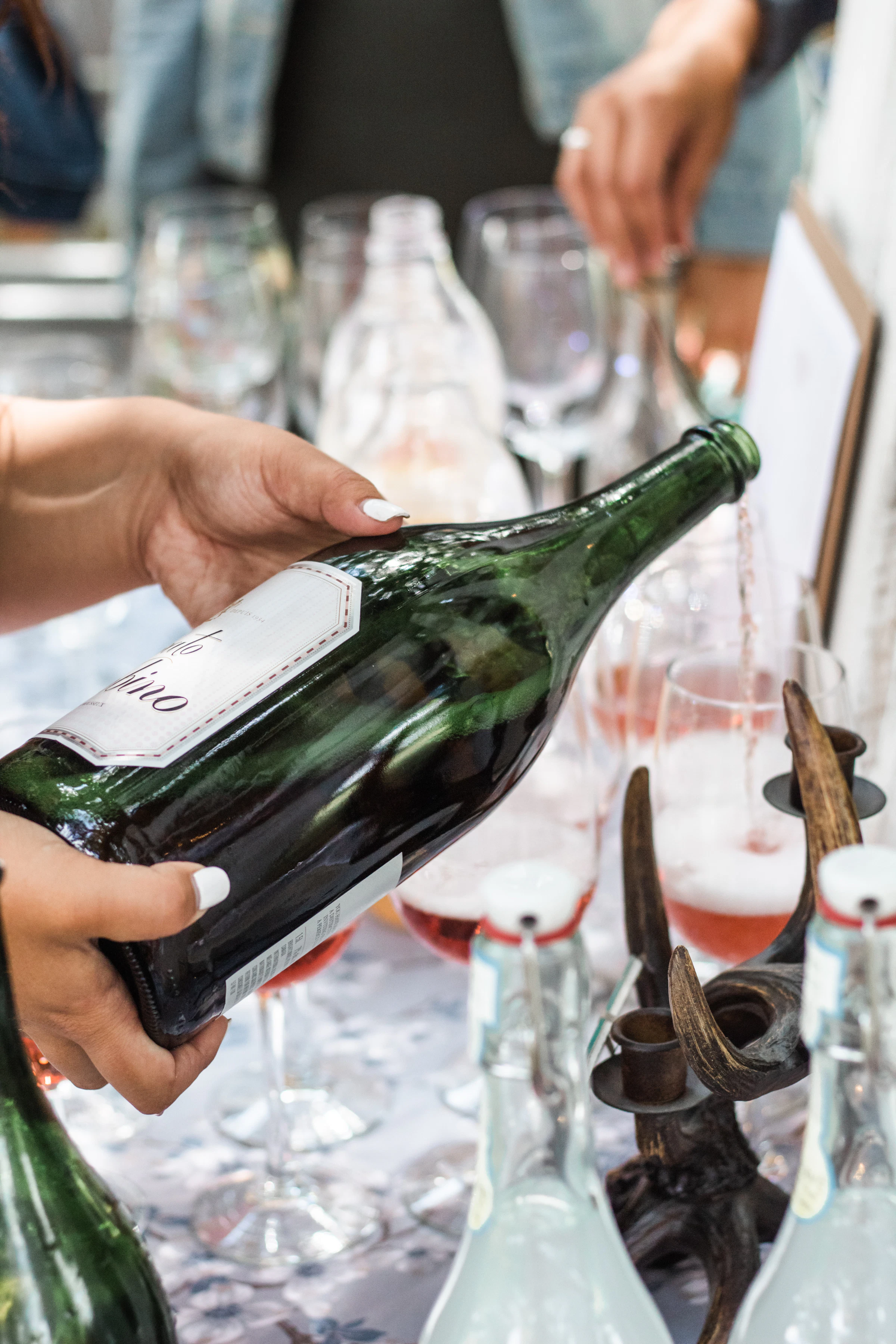 Champagne being poured into a green wine glass