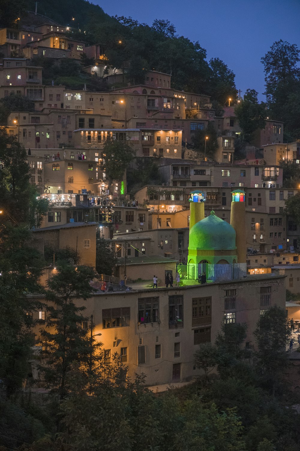 lighted houses on hill