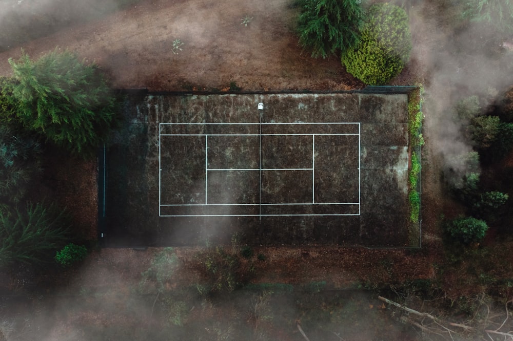 aerial photography field with white lines surrounded by trees