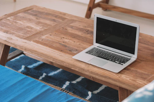 A cozy wooden coffee table with a smooth finish, set against a blue wall