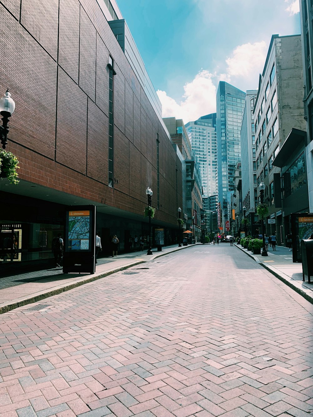 black signs beside road curbs during daytime