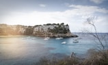 Sailing novera anchored at a picturesque bay surrounded by cliffs.