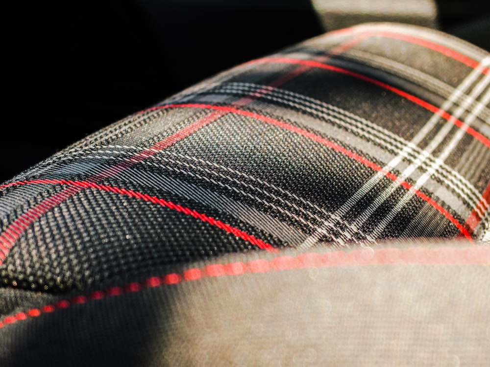 black, gray, and red plaid textile macro photography