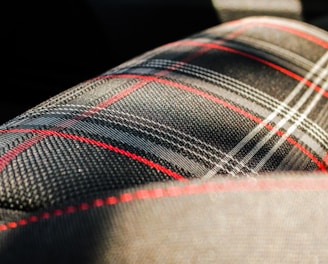 black, gray, and red plaid textile macro photography