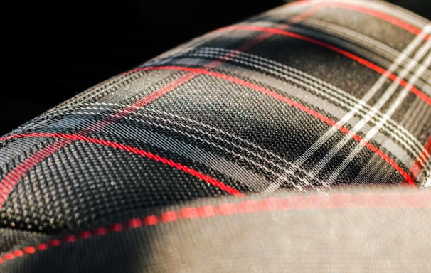 black, gray, and red plaid textile macro photography