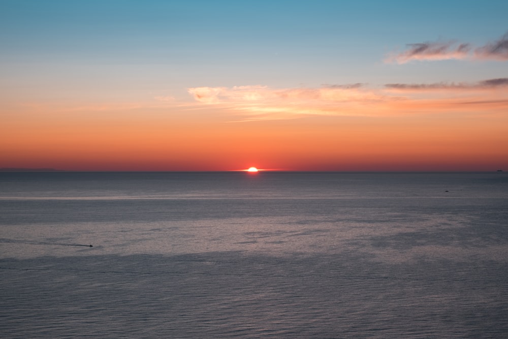 calm body of water during golden hour