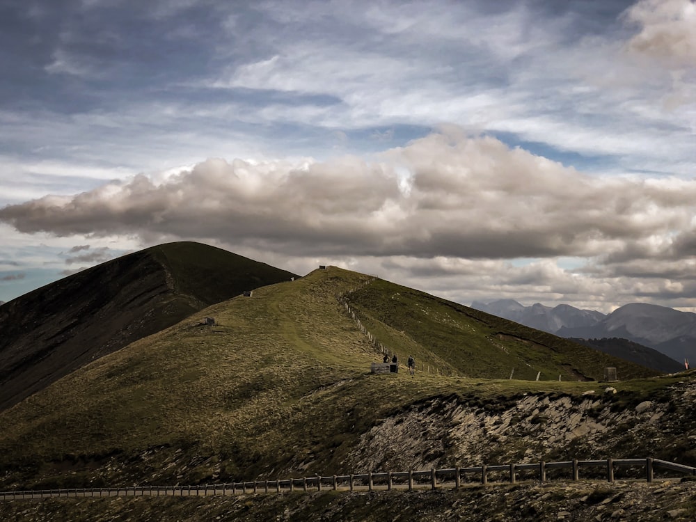 green mountain under white clouds during daytime