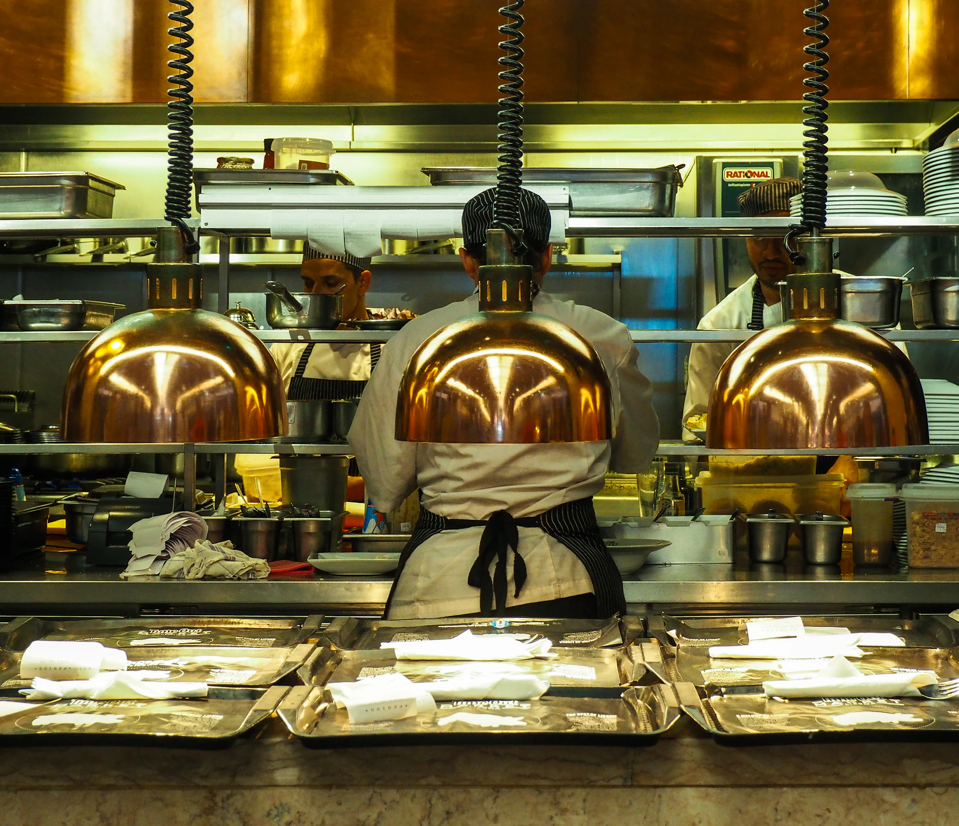 three grey stainless steel pendant lamps