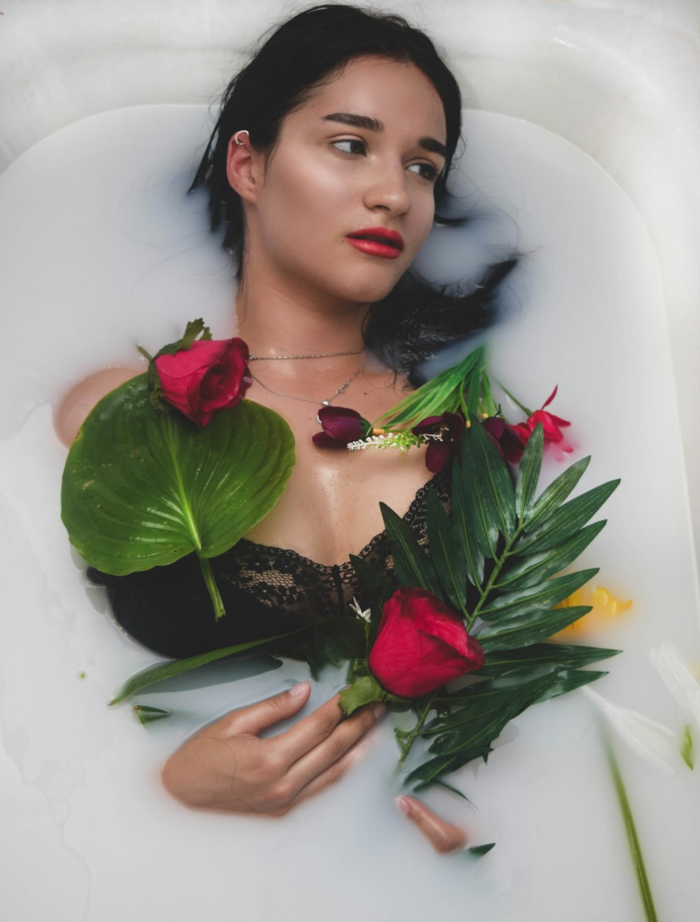woman on white bathtub with flowers