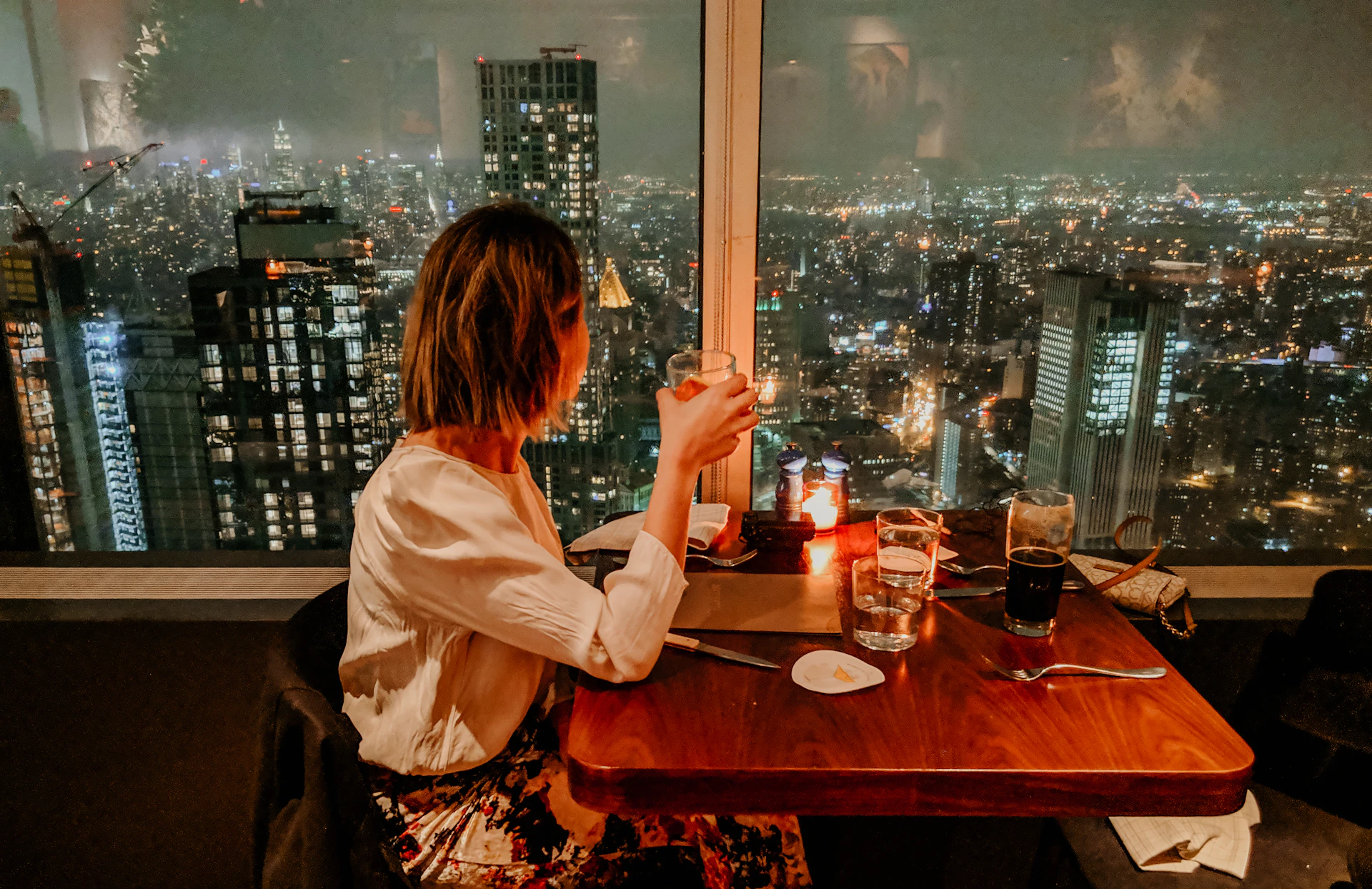 woman drinking on building