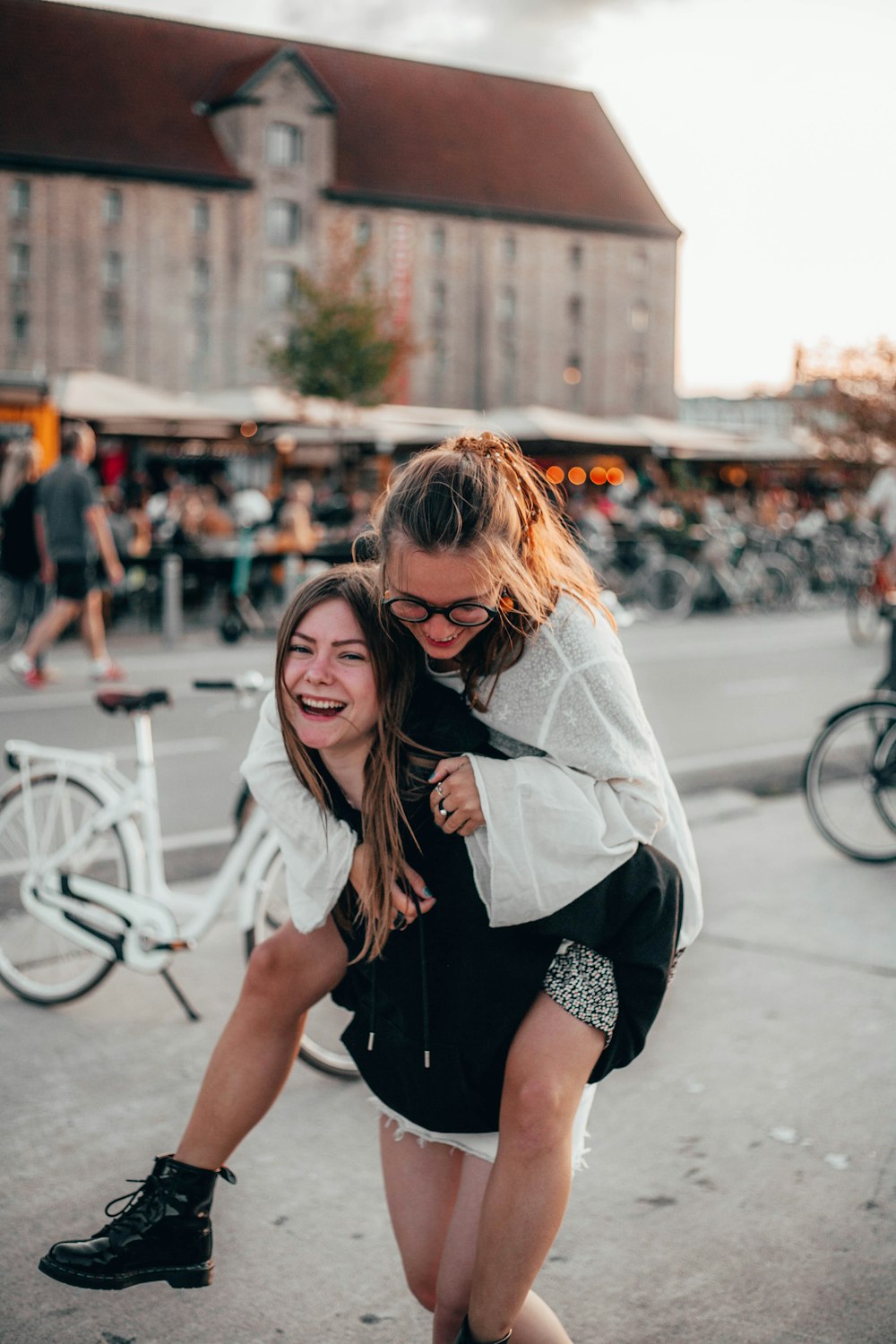 woman piggy back riding another woman